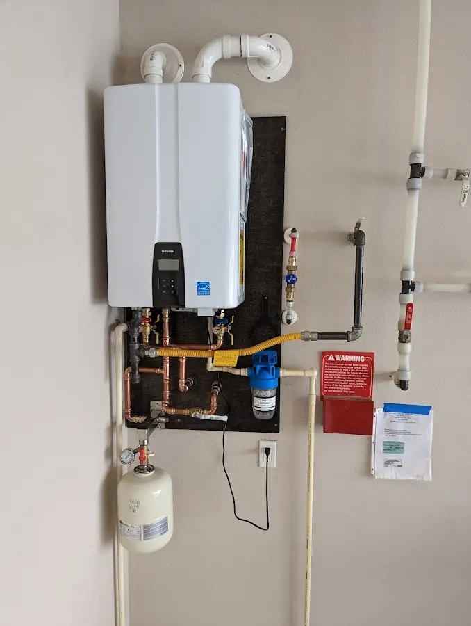 Professional plumber installing copper piping in a Island Park home